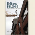 Book cover of 'Undoin Buildings' with a construction scene and crane.