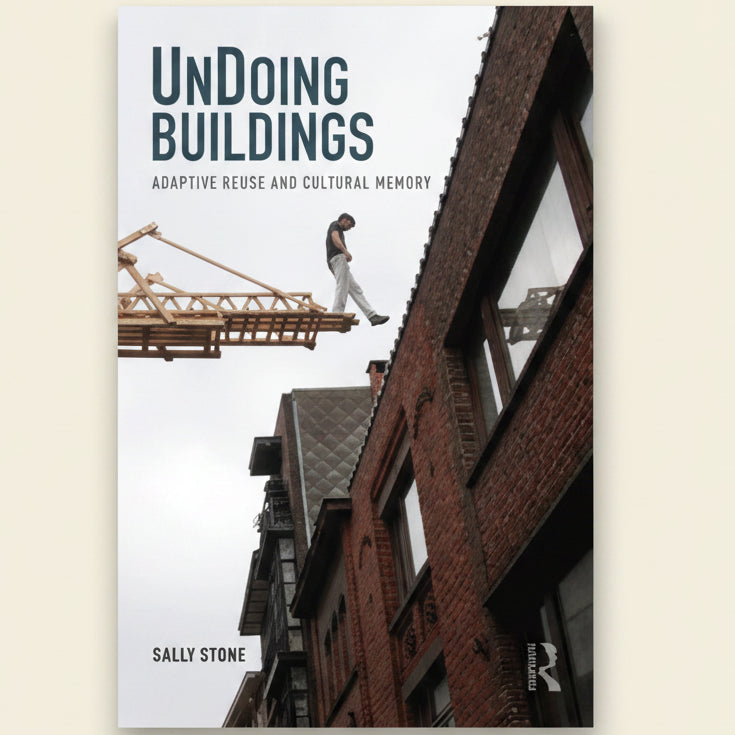 Book cover of 'Undoin Buildings' with a construction scene and crane.
