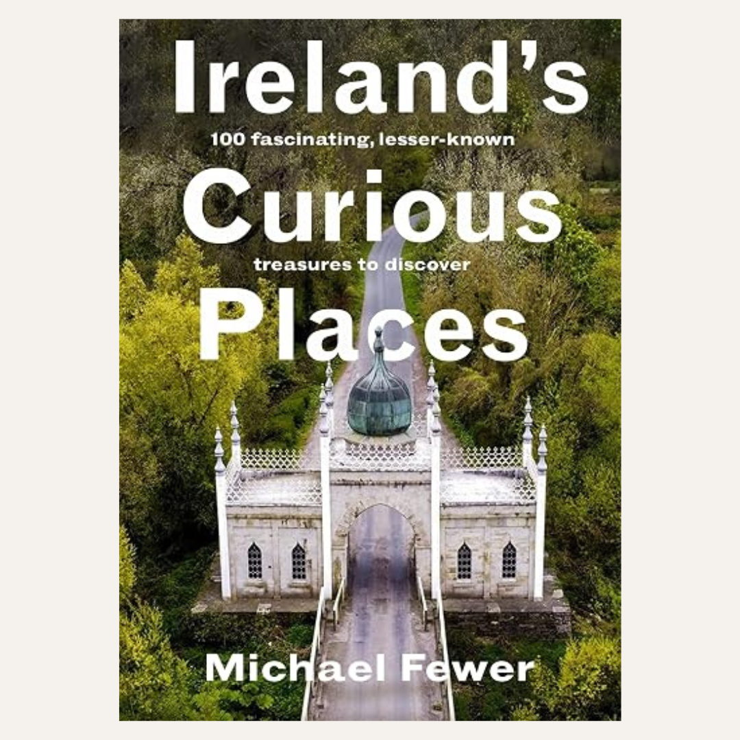 Book cover for 'Ireland's Curious Places' by Michael Fewer, featuring a white stone bridge and building surrounded by lush green forest, with large white title text.