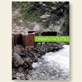 Urban facilities sign on a rocky cliff with water below