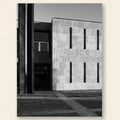 Black and white architectural photograph of a building with a textured wall.