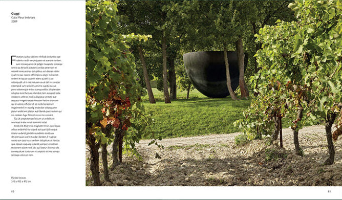 A printed magazine or brochure spread with a large outdoor photograph on the right showing a vineyard scene with a dark bowl-shaped sculpture in the background, and a text column on the left against a white page, all set within a muted green border.