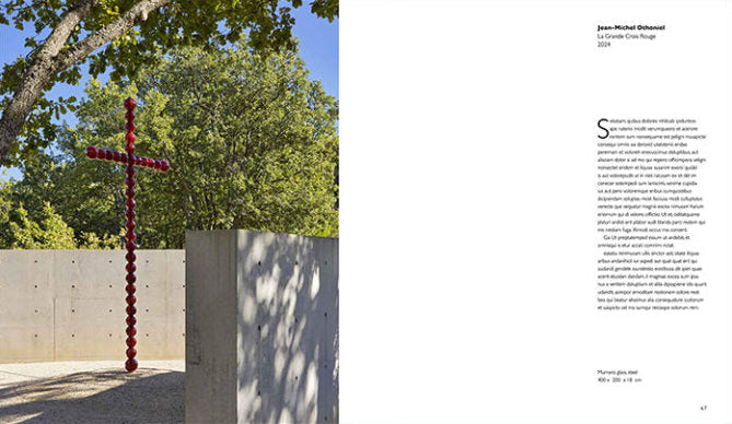 An open book or catalog spread showing a photograph of a red spiral cross outdoors against trees and concrete walls on the left page, and a text layout with the heading 'Jean-Michel Guérin' and body text on the right page, set against a muted green background.