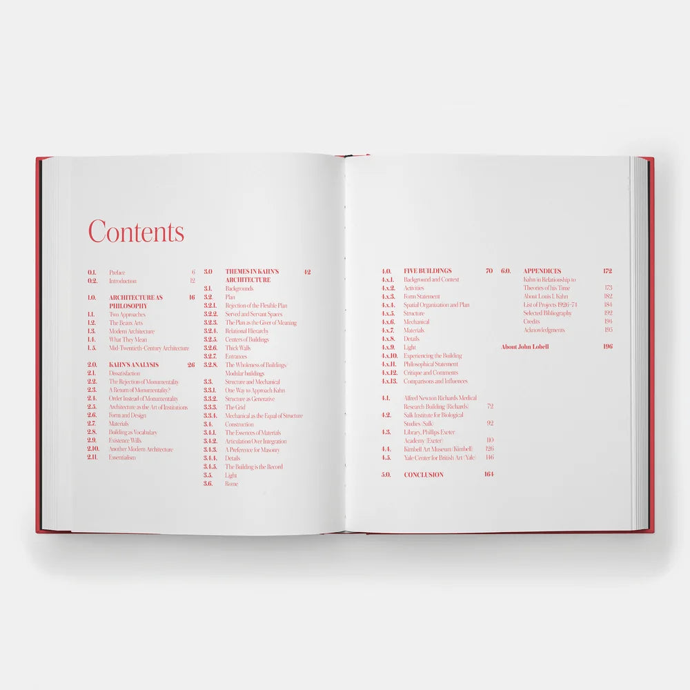 An open hardcover book showing the 'Contents' page with red text on white pages, photographed from above on a light gray background.