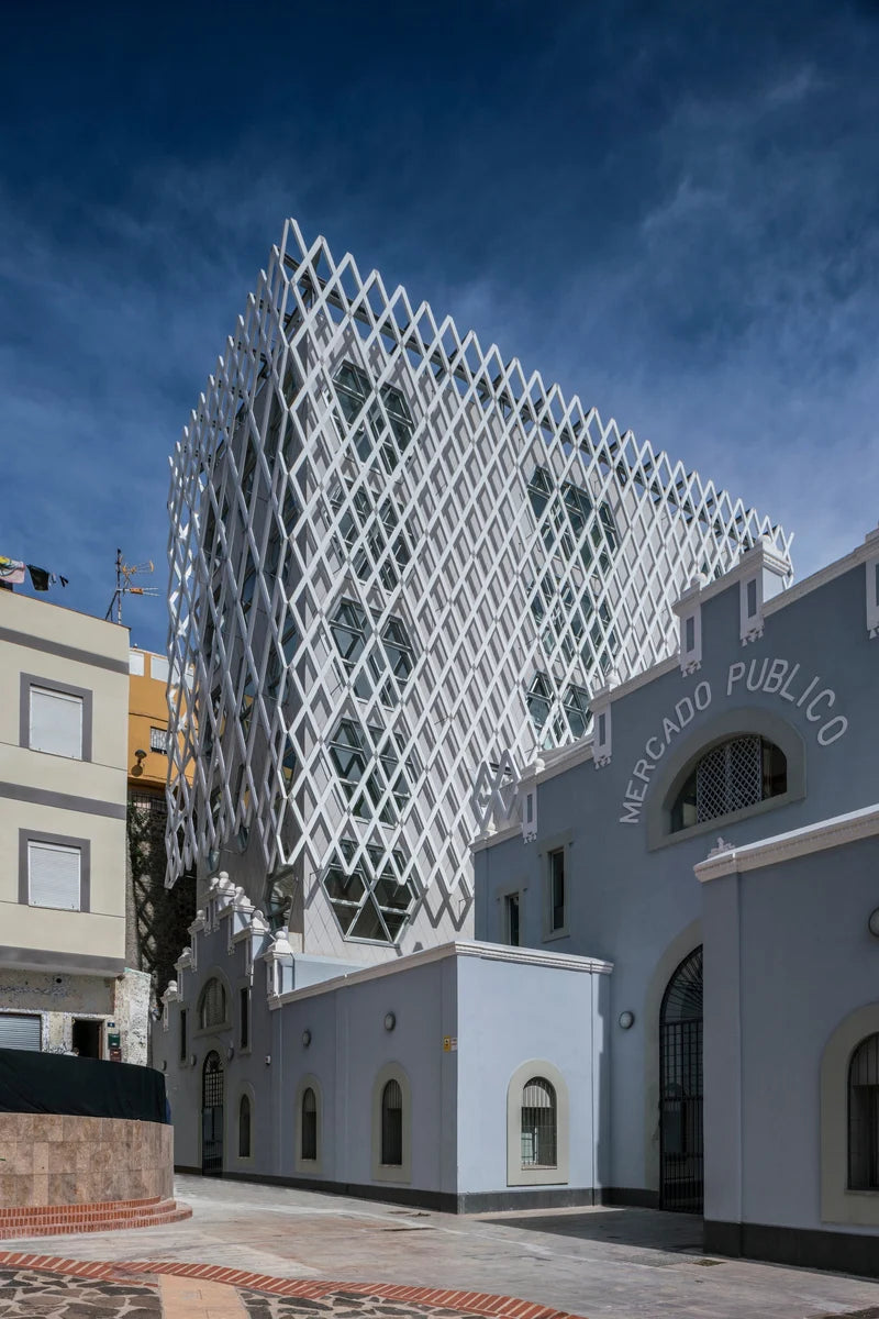 Modern architectural building with geometric facade against a blue sky