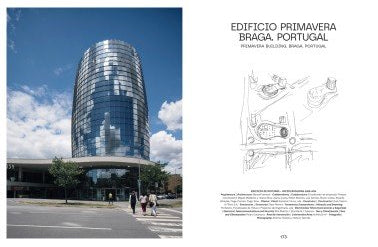 A printed architectural publication or brochure page showing a photograph of a modern cylindrical glass building in Braga, Portugal, alongside a black-and-white line drawing and text reading 'EDIFICIO PRIMAVERA BRAGA, PORTUGAL'.